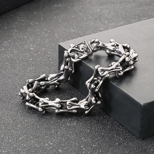 Close-up of punk style stainless steel skull buckle and bone link chain for men