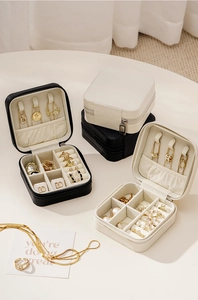 Close-up of portable leather jewelry box compartments for rings and earrings