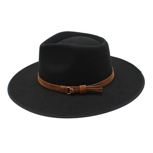 Detail of black wool fedora featuring a brown suede band and golden metal buckle accent