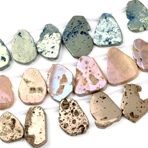 Polished irregular natural stone beads in blue, pink, and gold on a white background