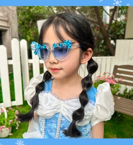 Detail of blue heart-shaped princess sunglasses with sparkling rhinestones and Elsa decal