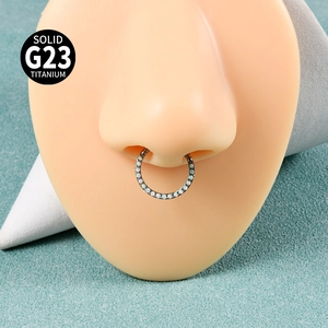Detail showing G23 titanium septum ring with white opal inlay on a nose model