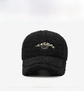 Close-up of black fleece baseball cap with white Peaches CHIZZY embroidery detail