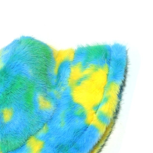 Macro shot of colorful tie-dye faux fur fabric showing thick gradient plush texture
