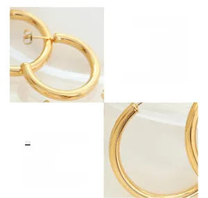 Detailed macro view of high-polished 18K gold-plated C-hoop surgical titanium earrings