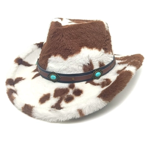Detail of cow print cowboy hat with turquoise accents and plush texture on white background