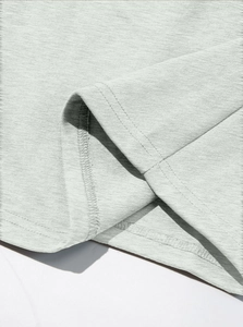 Detail showing high-quality double-needle stitching and knit texture on the grey coat hem