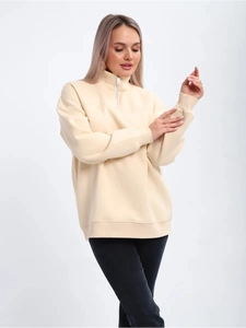 Detail of warm cream half-zip sweatshirt with stand collar and textured fleece finish