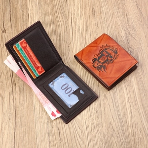 Vintage brown bifold men's wallet with embossed skull design and card slots