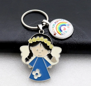 Detail of enamel rainbow charm and angel girl keychain with Schulkind 123 abc text