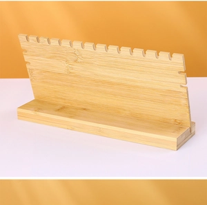 Close-up of natural bamboo necklace stand showing wood grain and storage notches