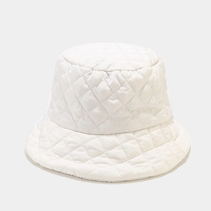 Detail of white quilted fisherman hat with diamond stitching and soft insulated padding