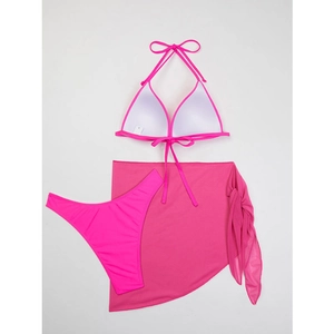 Detailed flat lay of hot pink three-piece bikini set with matching mesh sarong cover-up