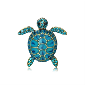 Creative turtle brooch with blue enamel and gold finish featuring sparkling rhinestones