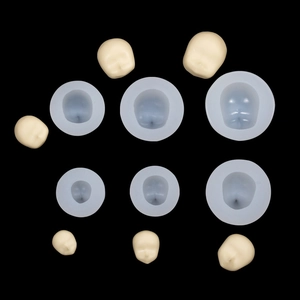 Set of 6 silicone face molds in various sizes for clay and fondant crafting on black surface