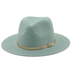 Close-up of mint green straw fedora hat featuring a fine weave and gold leather buckle belt
