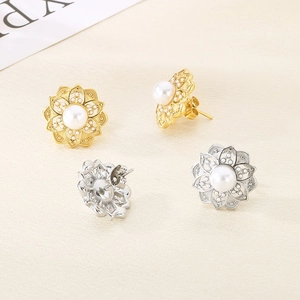 Macro detail of floral pearl earrings in gold and silver finish with petal accents