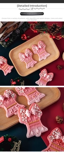Detail of pink Christmas bell fondant cookie mold with reindeer and snowflake patterns