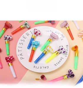 Colorful party blowouts with polka dots and stripes on a decorative display tray