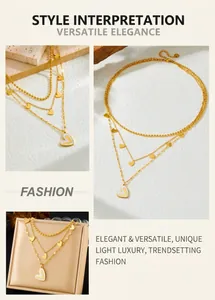 Detailed close-up of layered gold stainless steel necklace with white enamel heart pendants