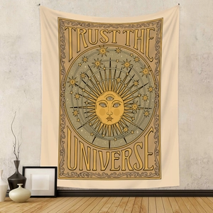Detail of bohemian sun tapestry featuring Trust The Universe text on wall