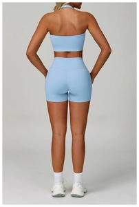 Rear view of light blue yoga set featuring a halter top and high-waisted fitness shorts