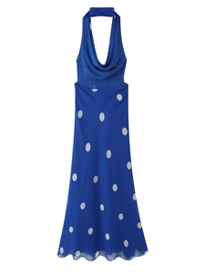 Detail of blue backless halter midi dress featuring large white polka dot pattern on chiffon