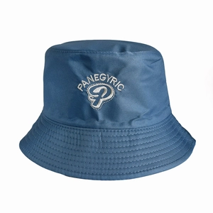 Close-up of Panegyric embroidery on a blue canvas sun hat with fine stitching details