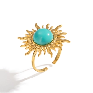 Close-up of golden sunburst ring with turquoise stone and adjustable band