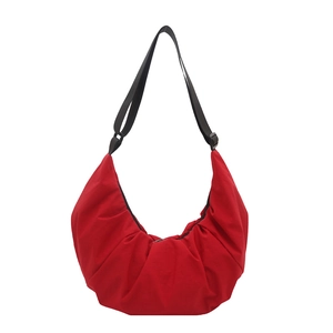 Large bright red nylon dumpling bag with adjustable black shoulder strap and pleated texture