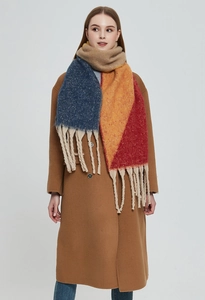 Detail of color-block knit scarf with thick tassels in beige, blue and orange