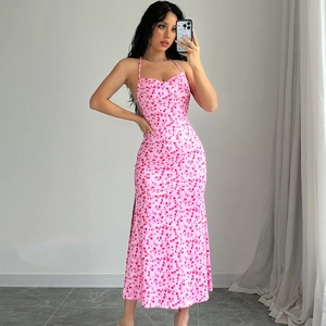 Detailed view of the pink floral halter dress featuring a side slit and backless design