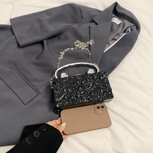 Acrylic evening clutch with ice crack texture, lion head handles and chain strap