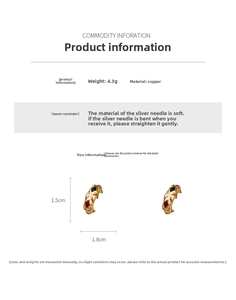 Macro detail of vintage C-shaped copper earrings with red and green enamel patterns