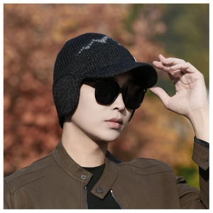 Detailed close-up of men's winter knit ear-flap hat with visor and thick fleece lining