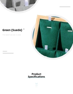 Detail of green and grey suede jewelry display tray with dividers for rings and necklaces