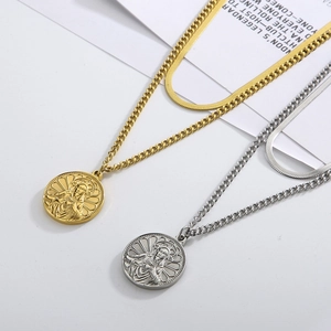 Detail of double-layer titanium steel necklaces with religious coin pendants in gold and silver