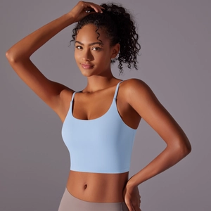 Detail of light blue yoga tank top with thin straps and smooth elastic fabric