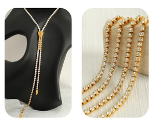 Detailed macro view of a gold zipper necklace featuring sparkling white rhinestones