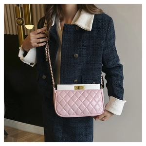 Detail of pink and white quilted PU leather crossbody bag with golden twist lock