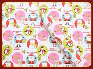 Detailed view of Christmas wrapping paper rolls featuring Santa, snowmen and festive patterns