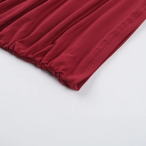 Detail view of dark red knitted fabric with elastic pleats and double-needle stitching