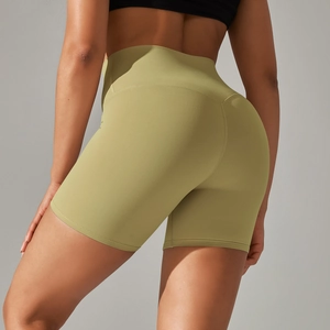 Close-up of high-waisted olive green yoga shorts featuring a V-shaped back seam for lifting