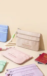 Multi-layer travel passport organizer with three zippers and lanyard in pastel colors