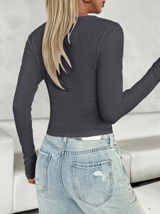 Detail of the back view of a dark grey ribbed long sleeve slim fit Y2K style top