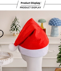 Close-up of red velvet Christmas hat with plush white trim on display head