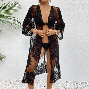 Detail of black lace beach cover-up with sunflower hollow-out embroidery and bell sleeves