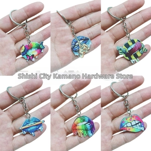 Set of six pop art acrylic lip keychains with colorful patterns and rainbow finish