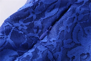 Detail of dark blue lace dress showing high-quality invisible zipper and floral texture