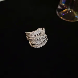 Elegant multi-layer silver ring with micro-pave cubic zirconia on a dark background